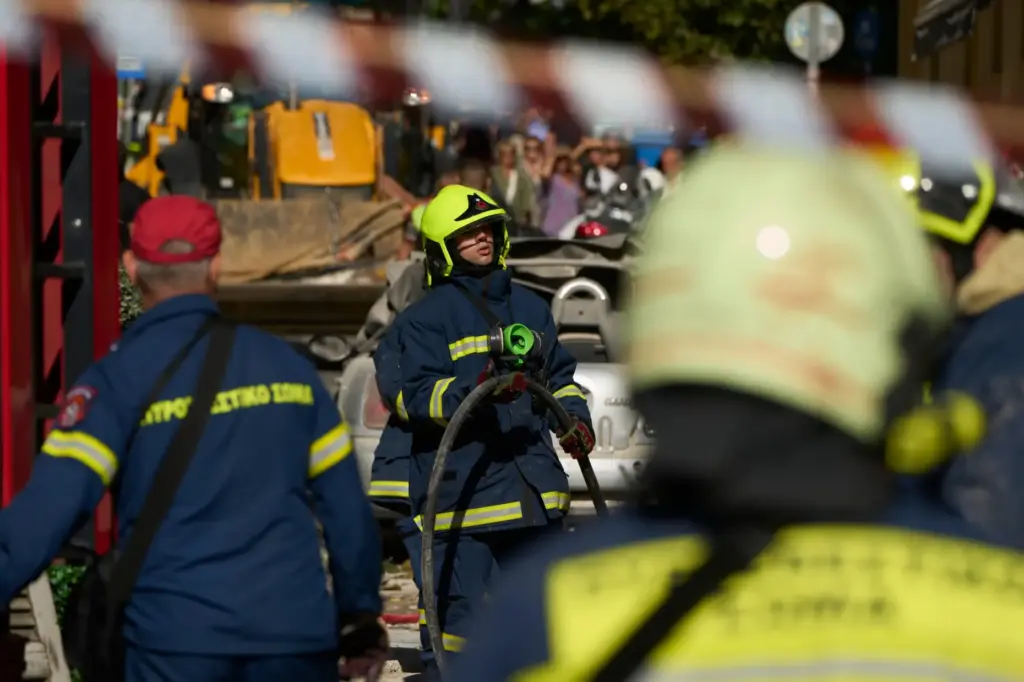 Firefighters work at the scene following a powerful blast that...