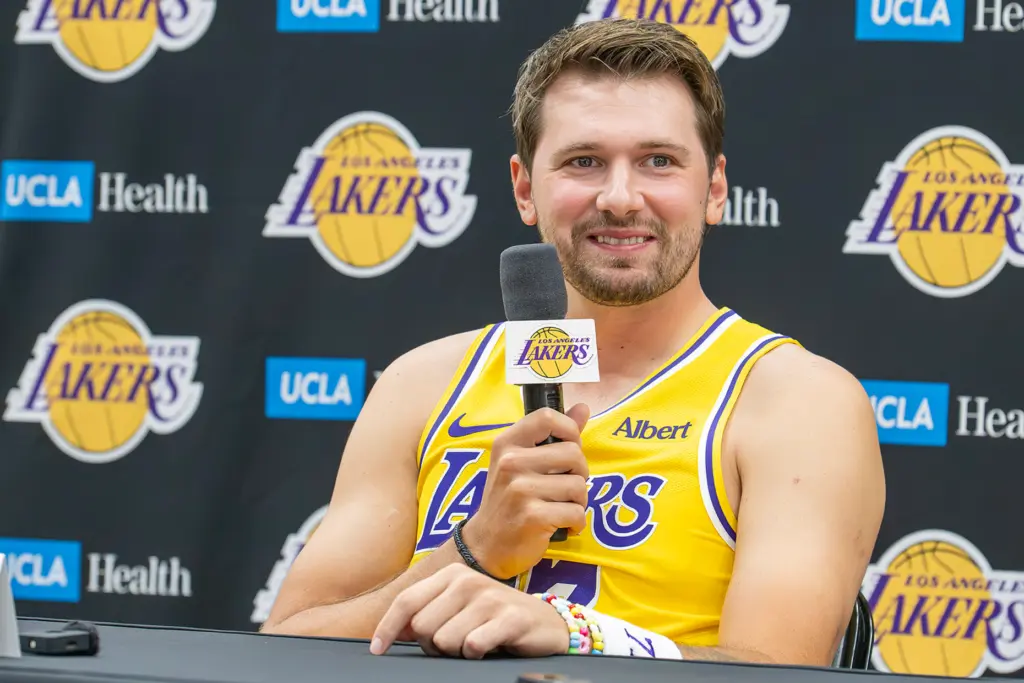 Luka Doncic listens to questions from reporters during the team's...