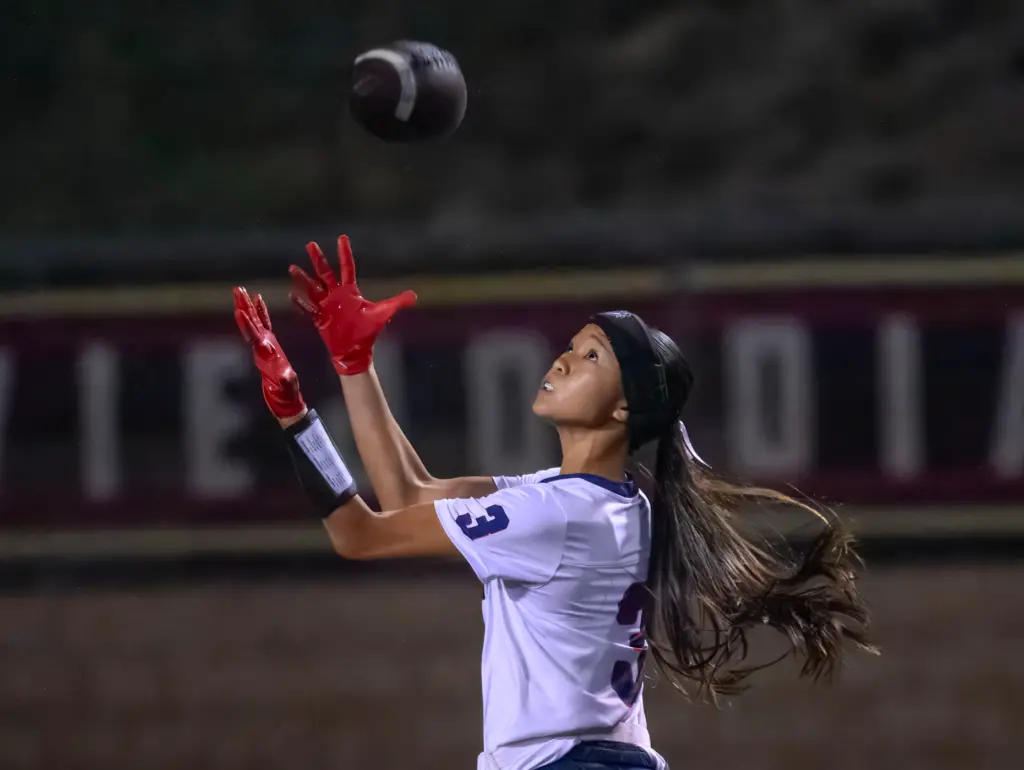 Beckman wide receiver Ava Chang pulls in a pass deep...