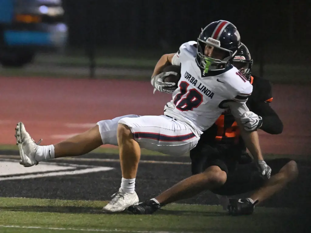 Yorba Lindaâs Maddex Schroeder (18) takes the ball to the...