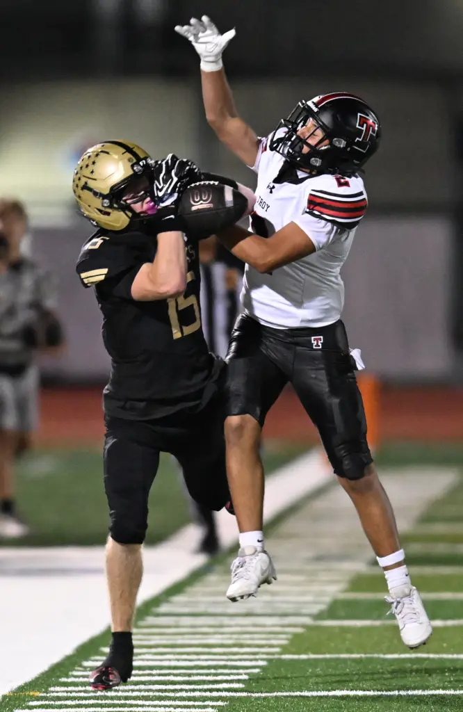 Noah Torosian #2 of Troy breaks up a pass intended...