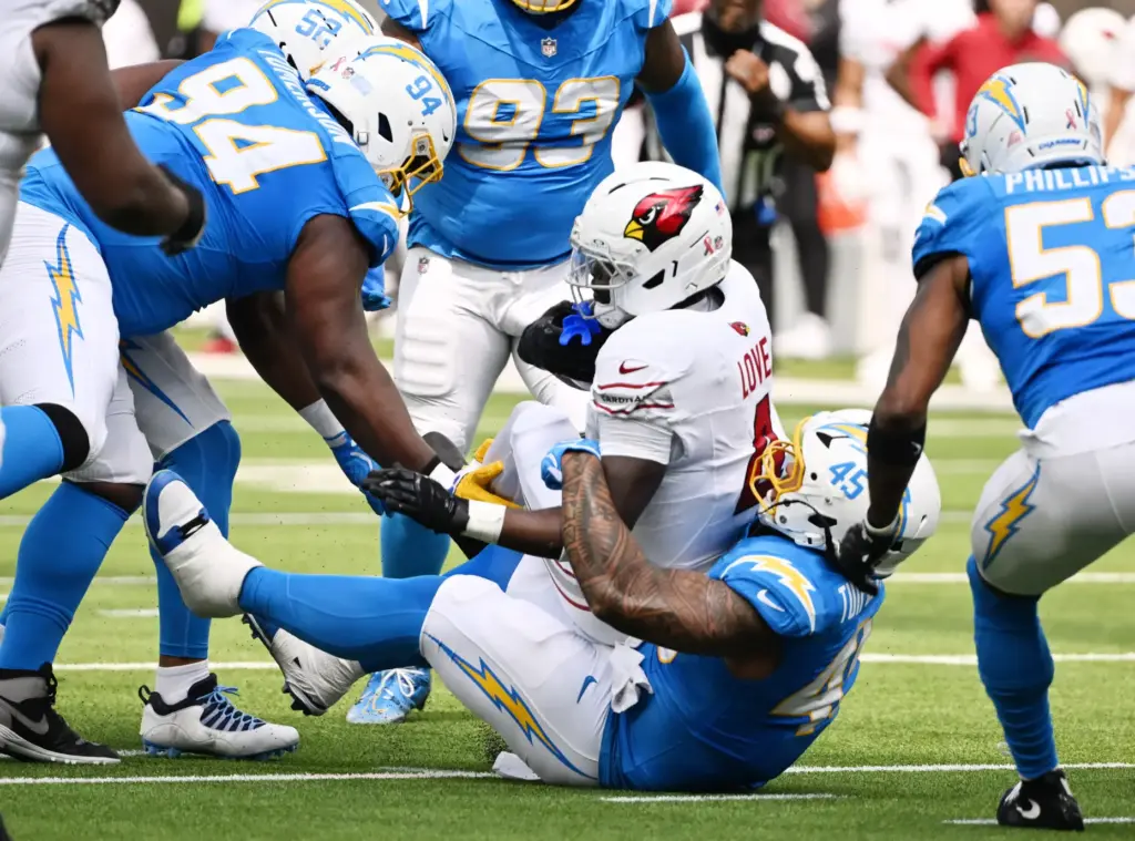 Chargers linebacker Tuli Tuipulotu (45) tackles Arizona Cardinals running back...