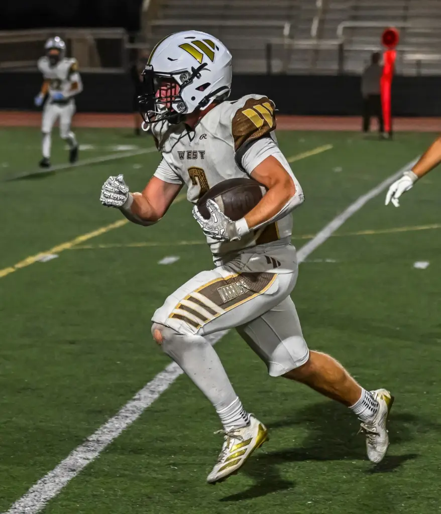 West Torrance running back Jack MacInnis runs with the ball...