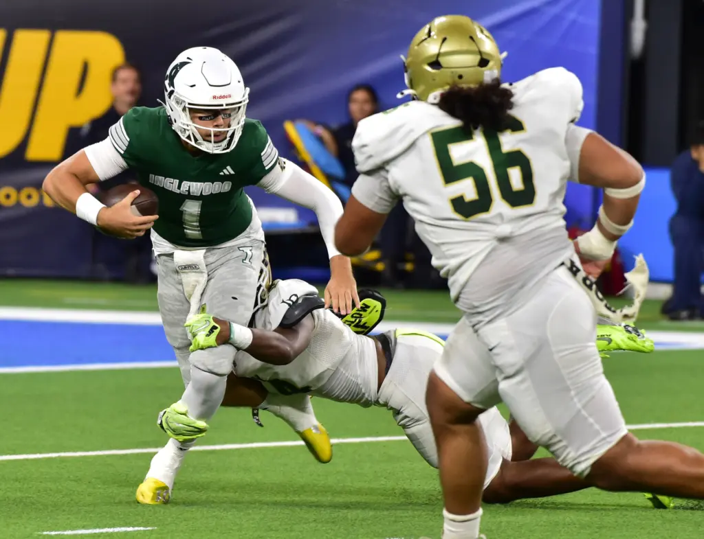 Inglewood QB Lincoln Jahn is sacked by Long Beach Poly’s...