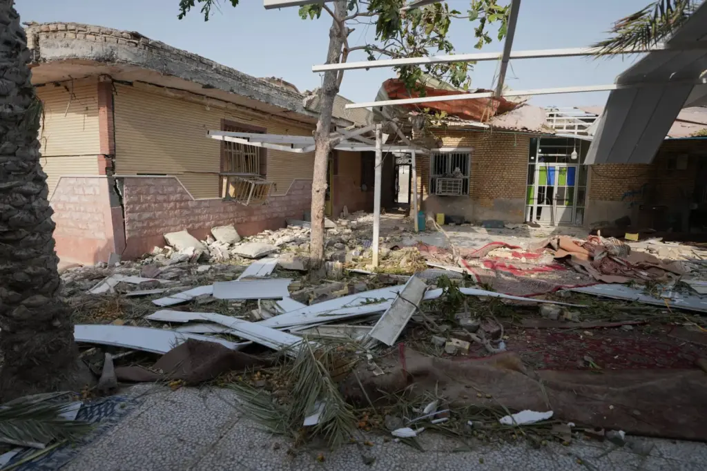 Debris is scattered across the courtyard of a building that...