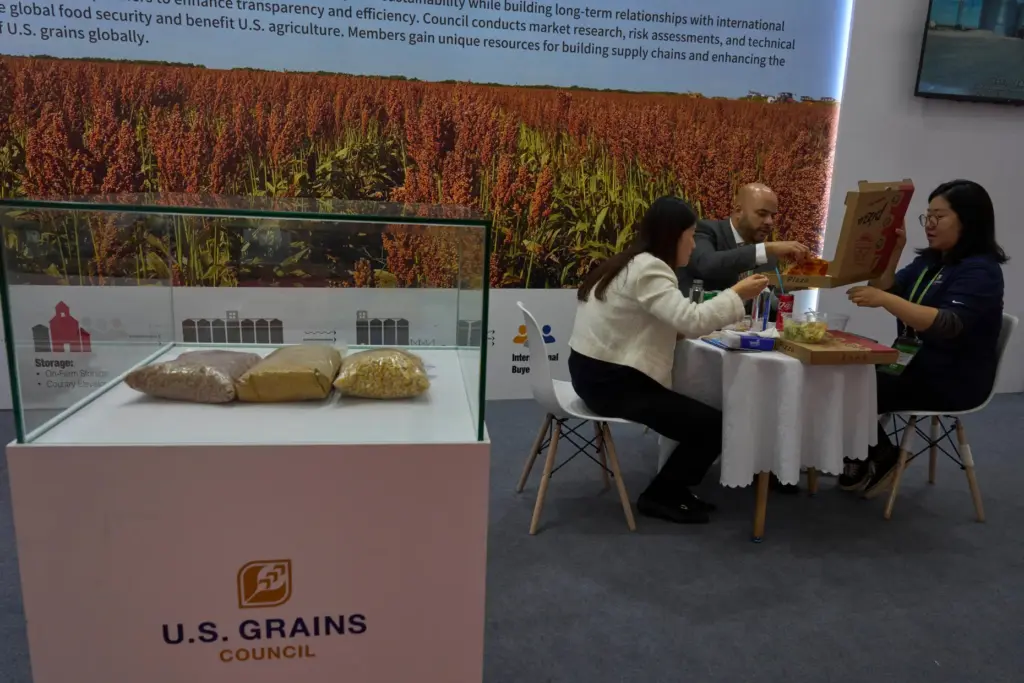 Workers eat lunch at the U.S. Grains booth during the China International Supply Chain Expo.