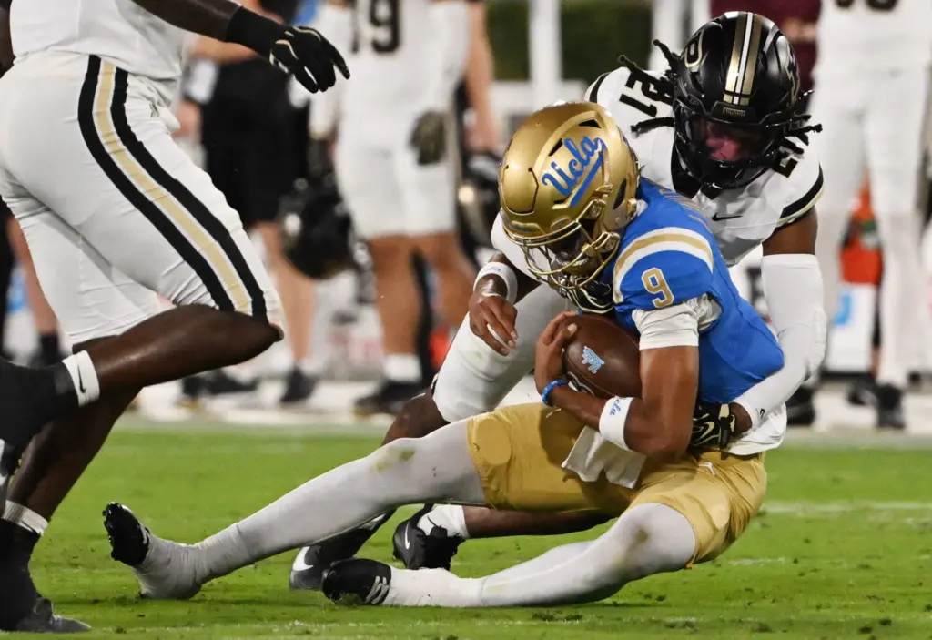 Quarterback Nico Iamaleava (9) of the UCLA Bruins scrambles for...