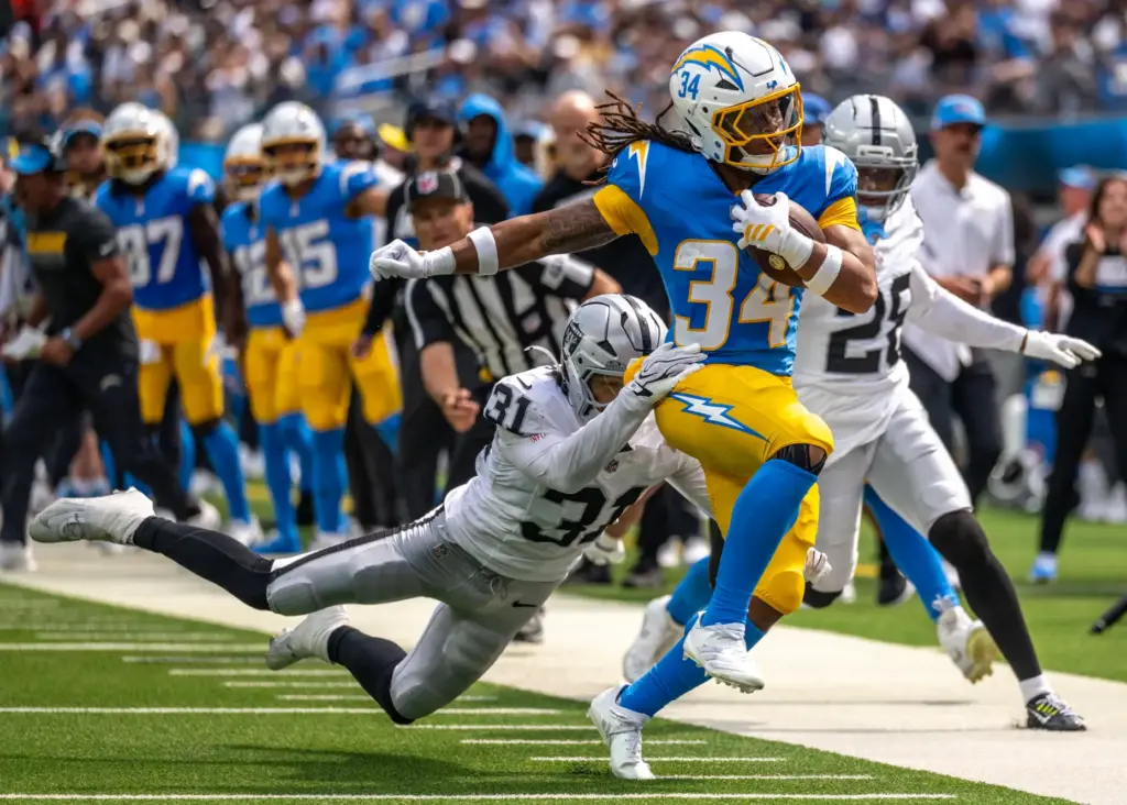 Chargers running back Keaton Mitchell (34) breaks a tackle by...