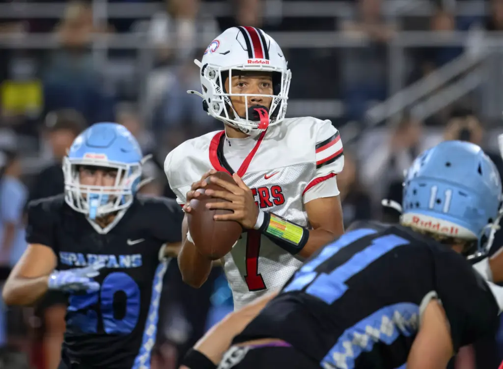 Lakewood quarterback Aidan Kautsky looks for a receiver under pressure...