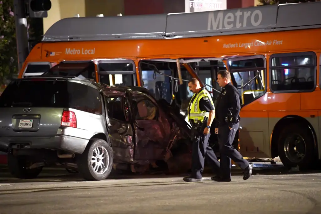 First responders investigate the scene following a collision between a...