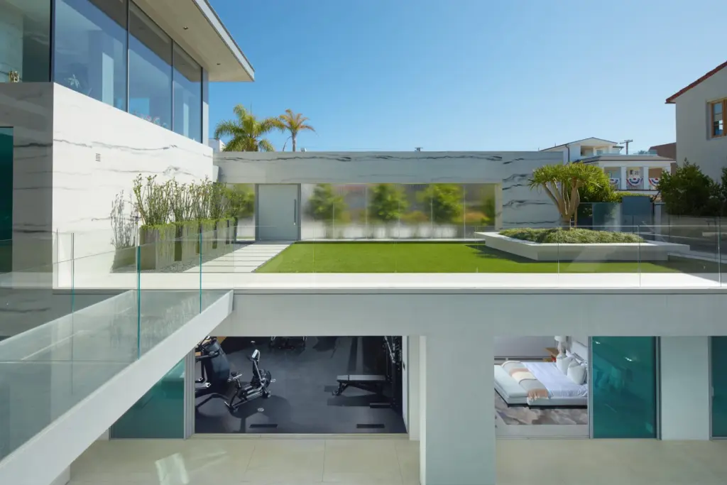 A glass bridge spans the home’s lower level. (Courtesy of...