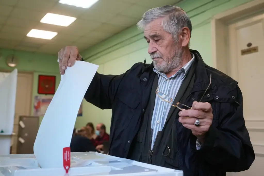 A voter casts a ballot in the parliamentary election in...
