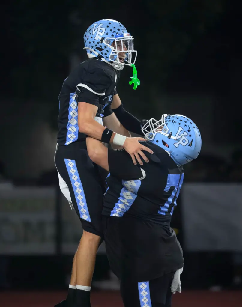 Villa Park wide receiver Sean Byrnes, left, is lifted high...
