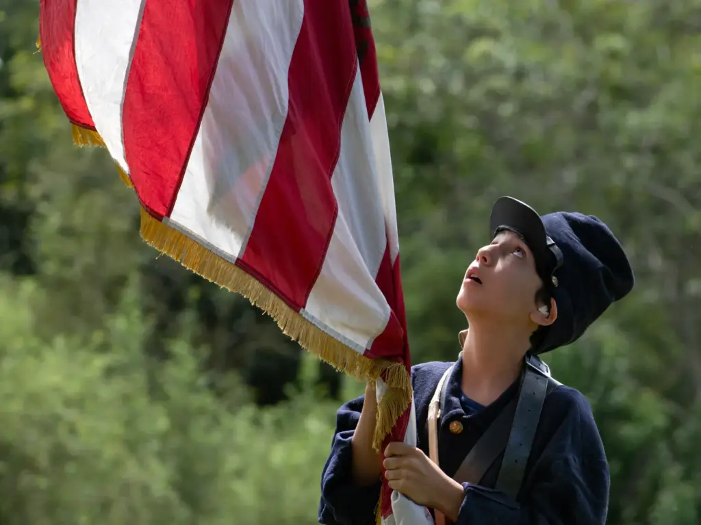 A color bearer carries the flag into the battlefield during...