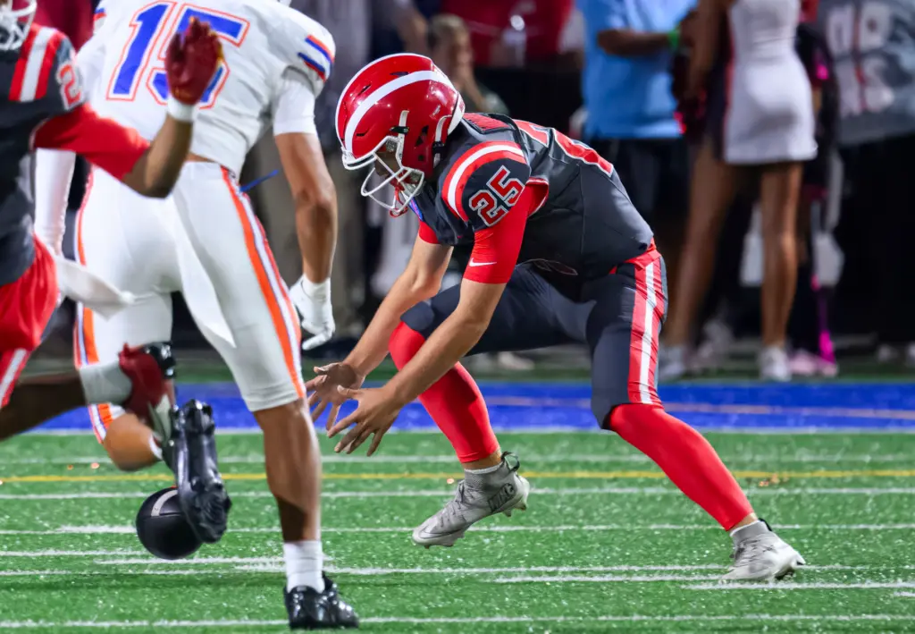 Mater Dei punter Campbell Bulger scrambles for the ball after...