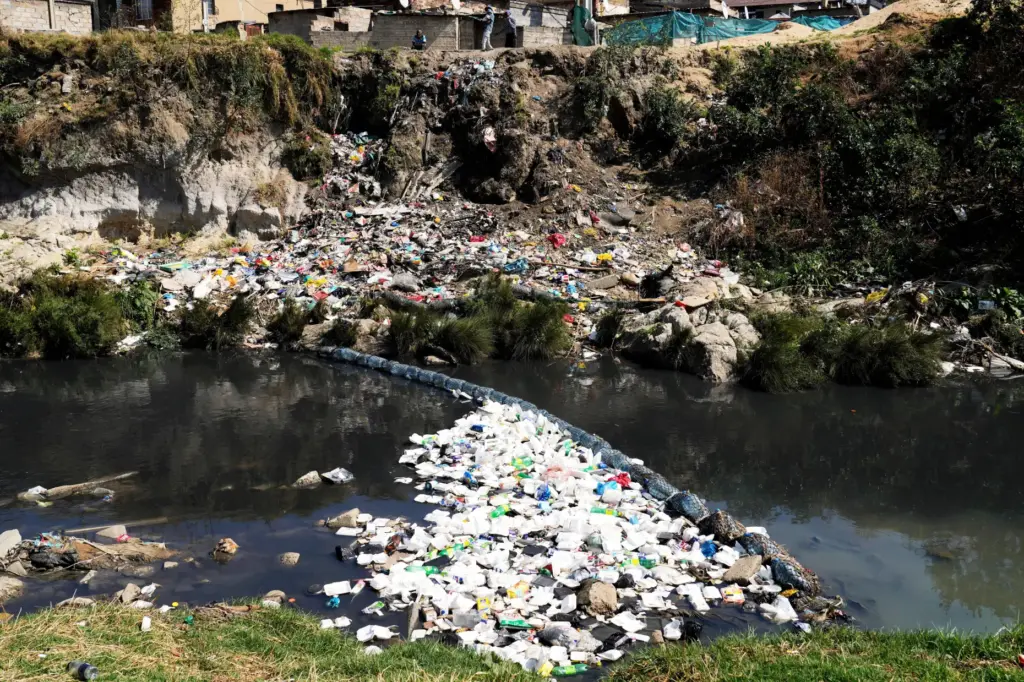 Piles of plastic waste and debris float along the Jukskei...
