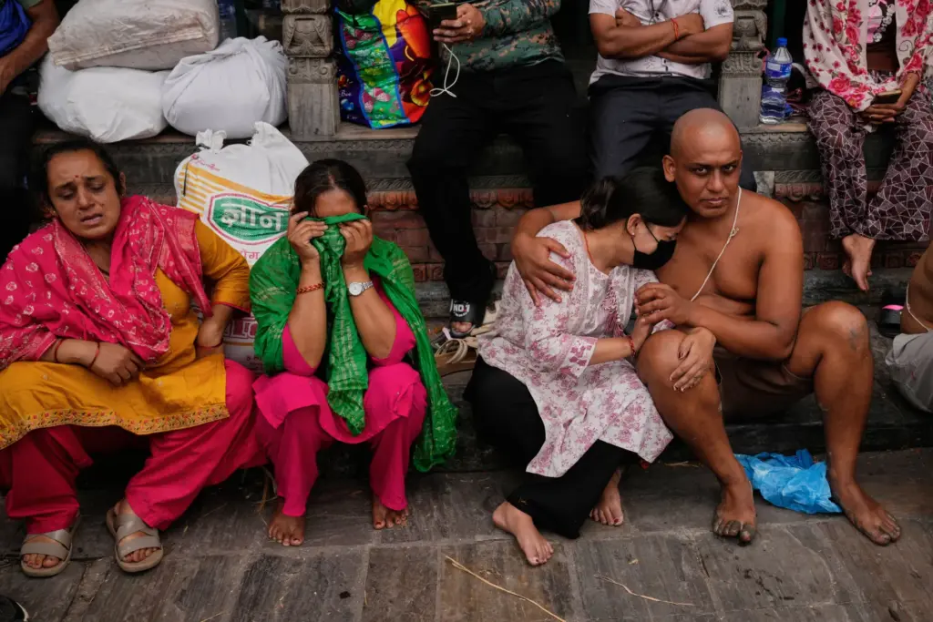 A man comforts a woman after he performed rituals during symbolic last rites.