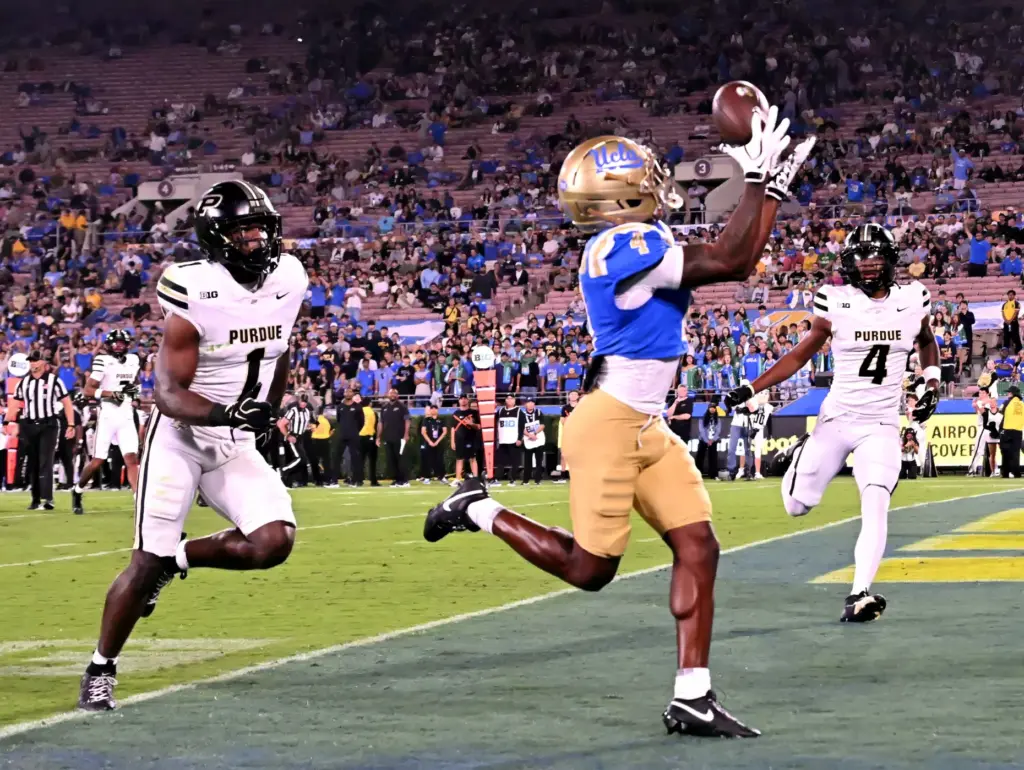 Wide receiver Semaj Morgan (4) of the UCLA Bruins catches...