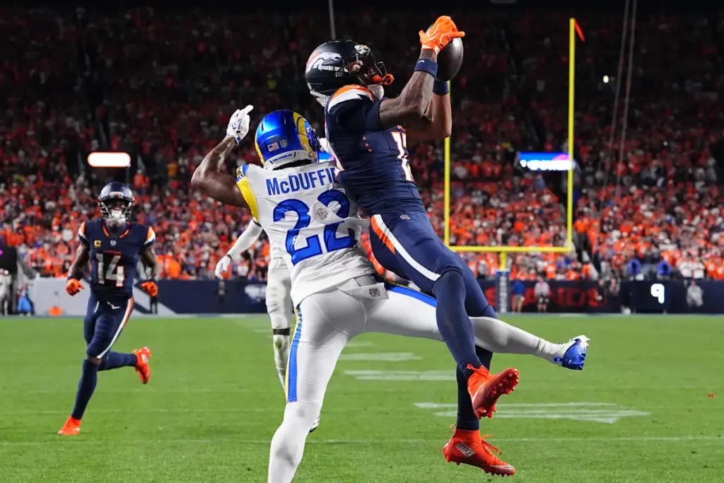 Denver Broncos wide receiver Pat Bryant, right, catches a catch...