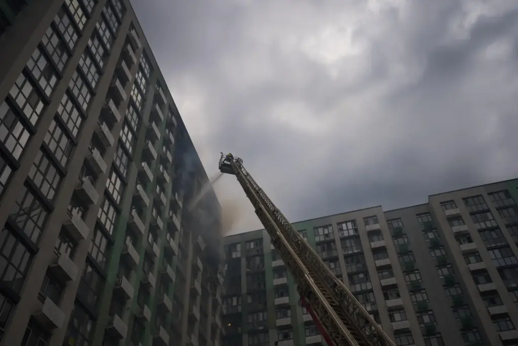 Firefighters work after a Russian drone attack struck a residential building in Kyiv.