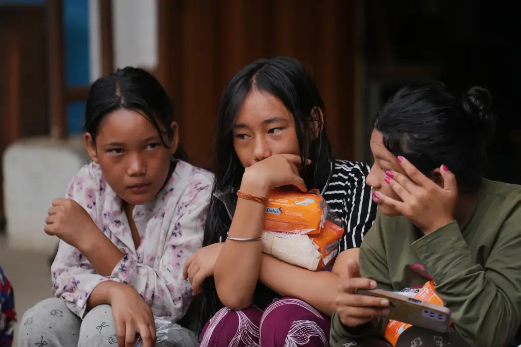 Displaced girls sit at a school converted into a temporary shelter.