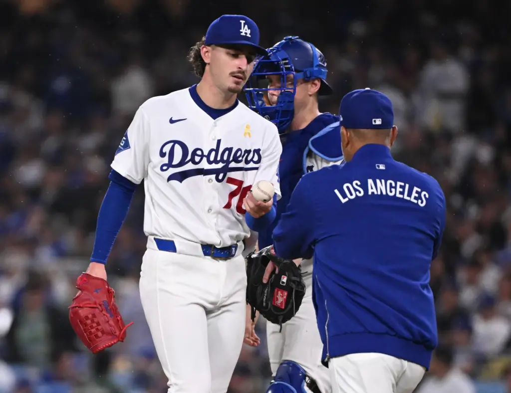 Dodgers manager Dave Roberts takes the ball from starting pitcher...