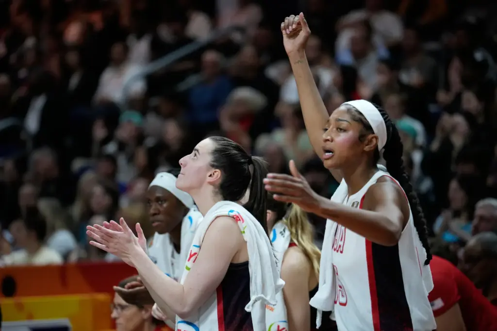 Team USA’s Caitlin Clark, left, and Angel Reese react from...