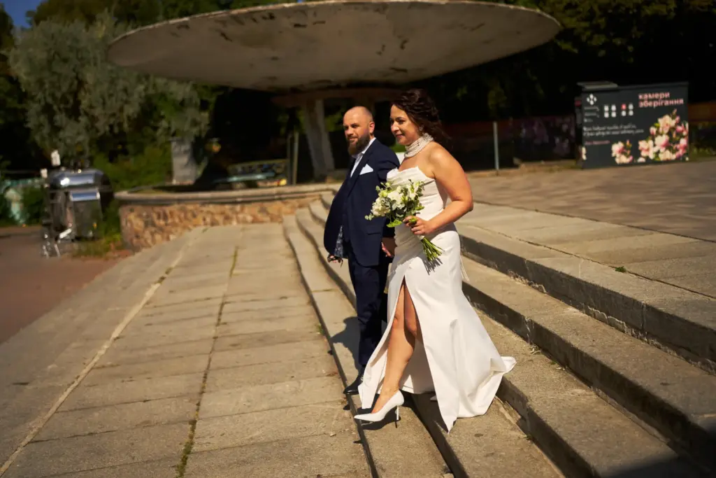Newlyweds Iryna Baranova and Evhen Mytsyk leave after their wedding portrait session.