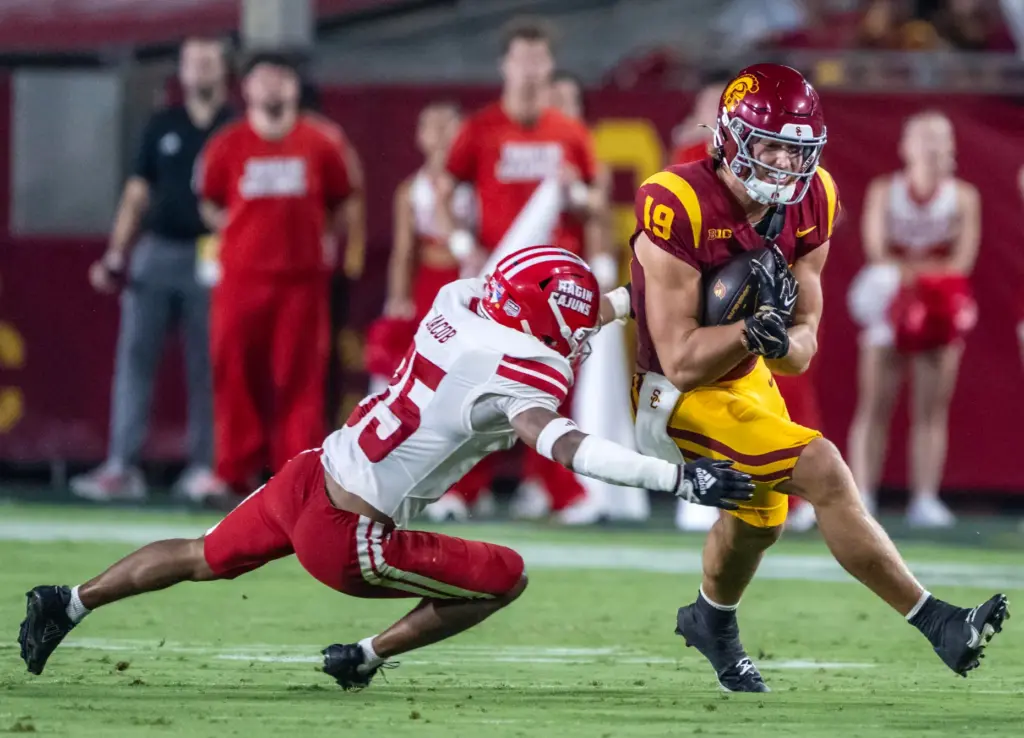USC tight end Mark Bowman (19) breaks a tackle while...