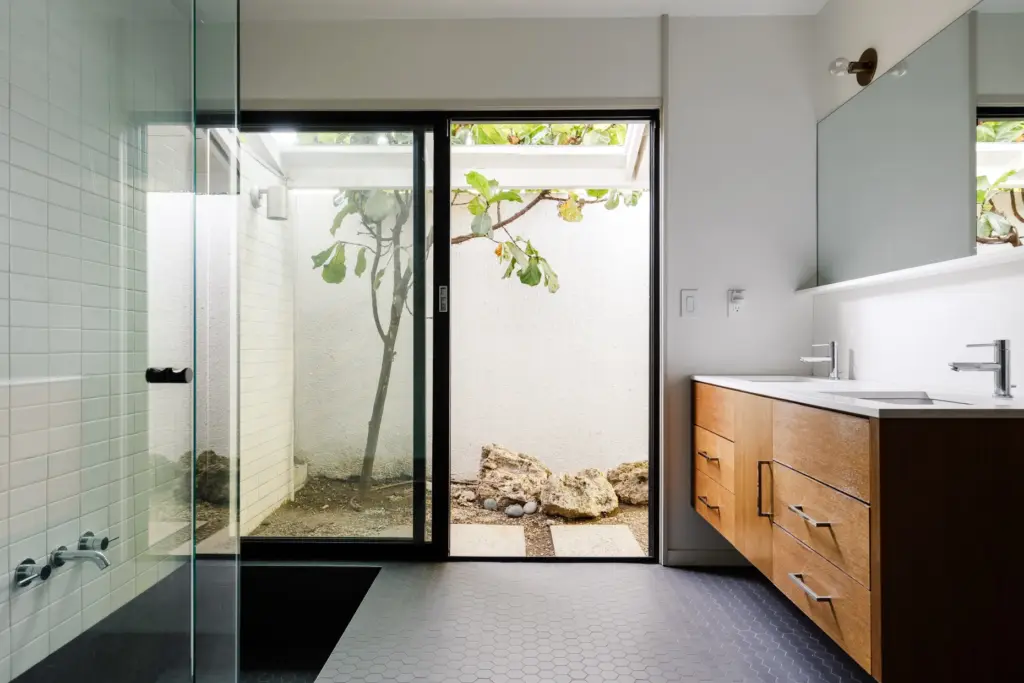 The primary bathroom’s sunken tub and separate shower. (Photo by...