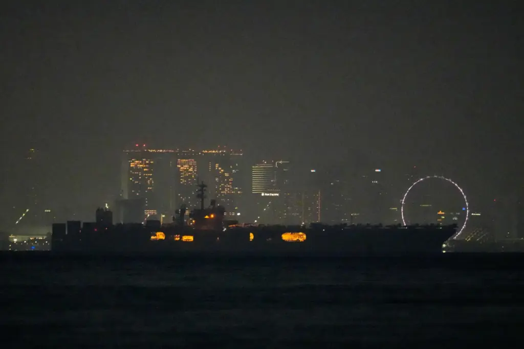 The U.S. Navy aircraft carrier USS Abraham Lincoln sails past Singapore.