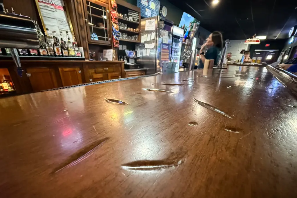 Dents from a hatchet attack on the bar top at...