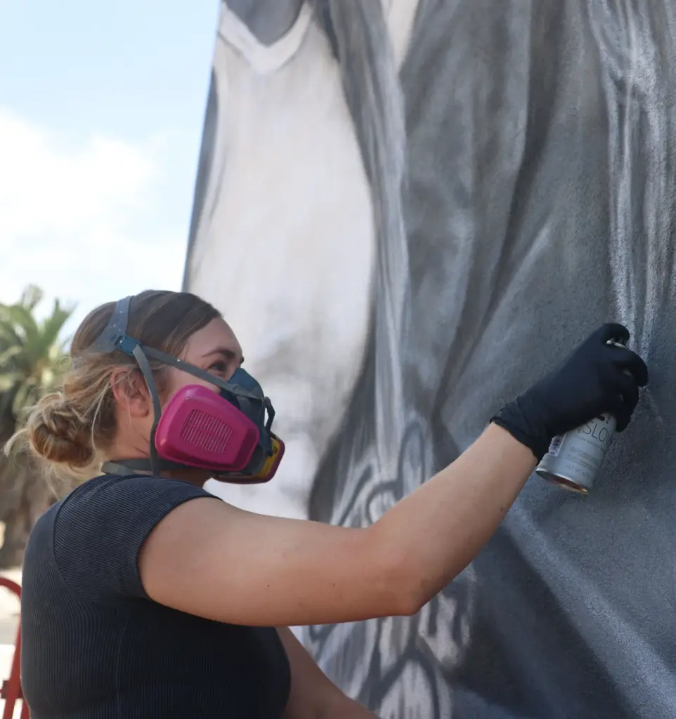 Artist Julie Engelmann of Half Moon Bay paints a mural...