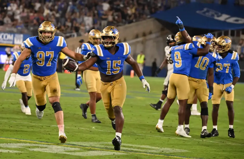 Defensive lineman Sahir West (15) of the UCLA Bruins recovers...
