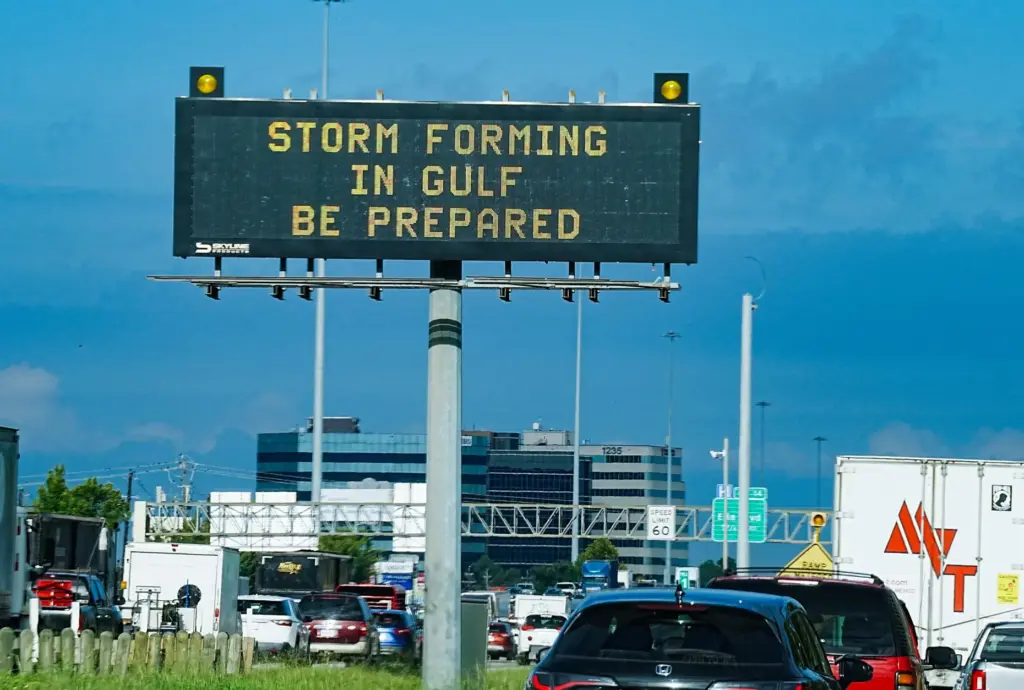 Motorists drive by Texas Department of Transportation signs on I-610...