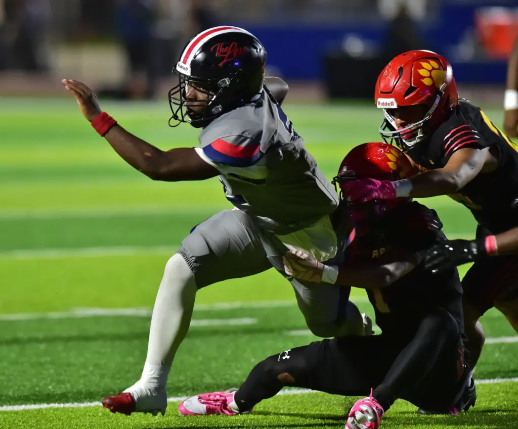 Leuzinger back Milton Jeffersongets dragged down by Hawthorne defense in...