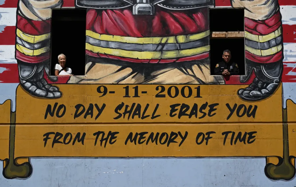 Muralist Rosie Tos, left, and retired firefighter Fernando Negrete in...