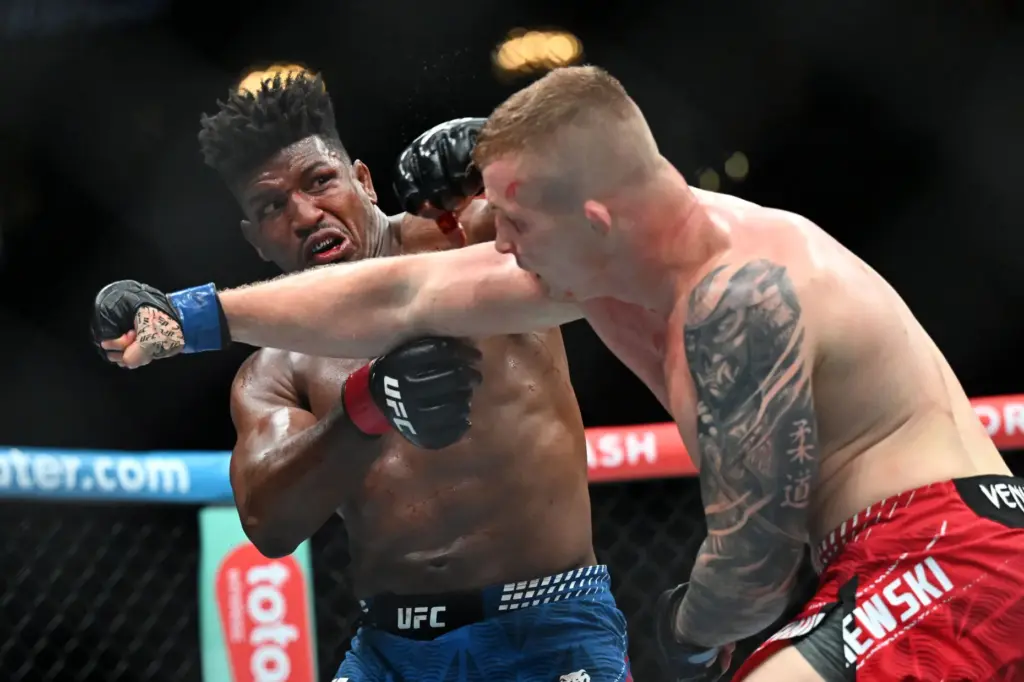 Alonzo Menifield throws a punch at Iwo Baraniewski during their...
