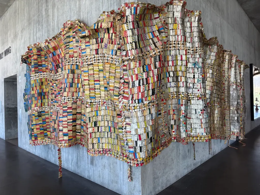 An African textile creation is hung on a gallery corner...