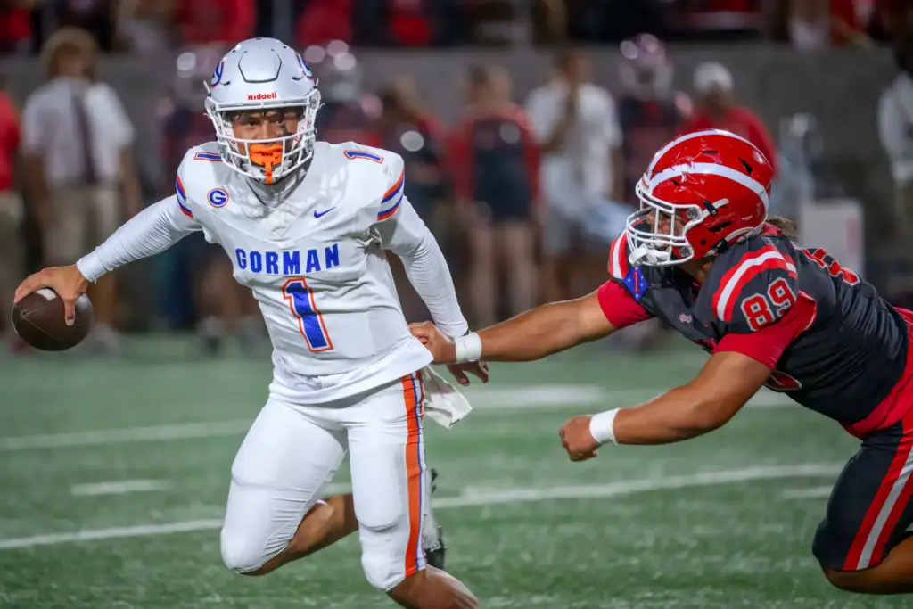 Bishop Gorman quarterback Ace Amina, left, avoids getting sacked by...