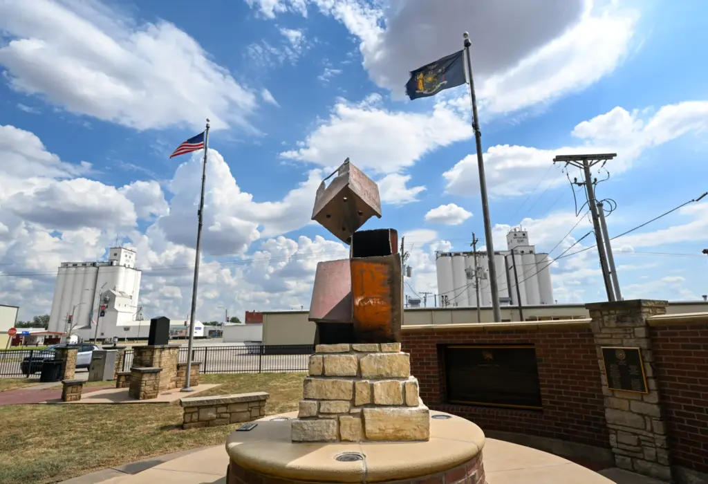 Grain elevators flank three piece of twisted steel from the...