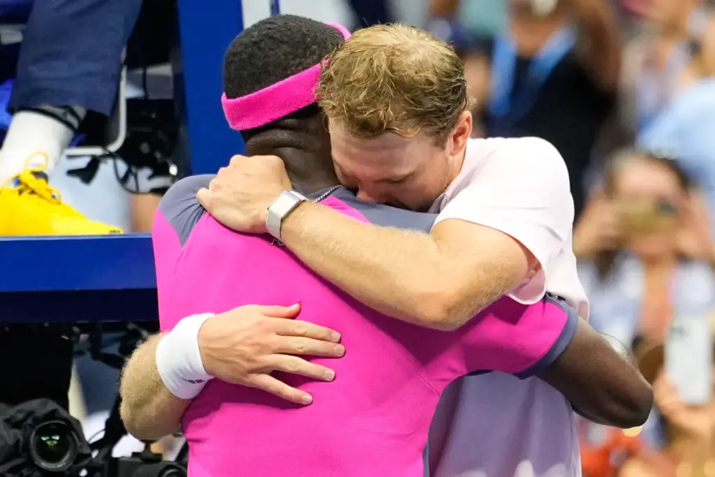 Frances Tiafoe, left, and Laguna Hills’ Alex Michelsen embrace after...