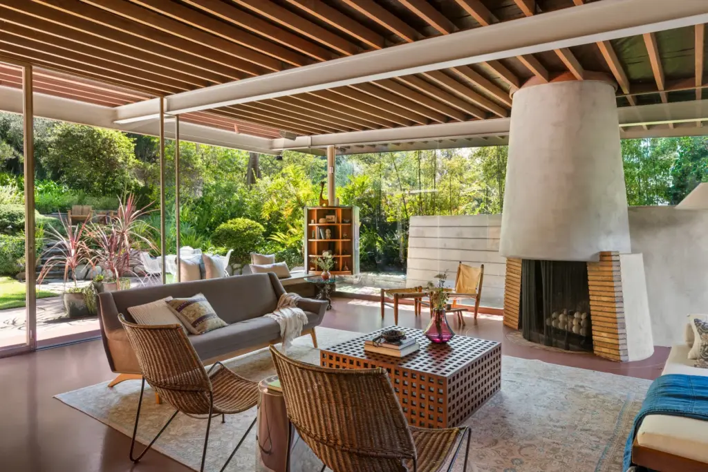 A conical fireplace anchors the living room. (Photo by Cameron...