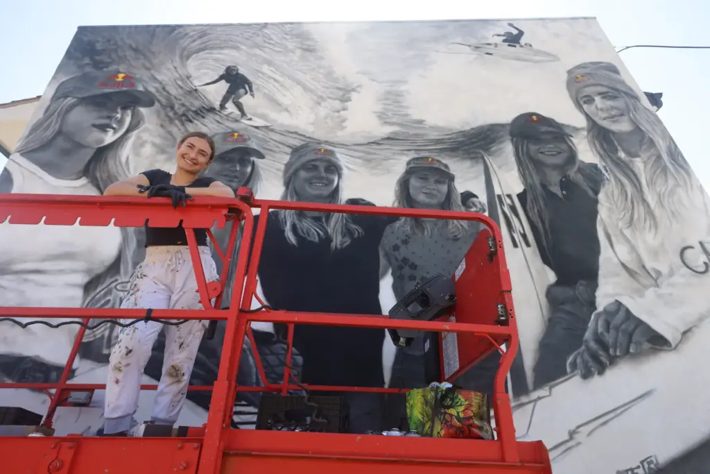 Artist Julie Engelmann of Half Moon Bay paints a mural...