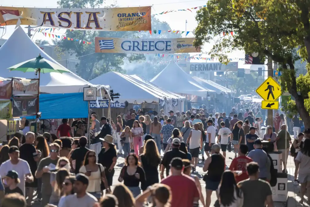 Thousands of fairgoers fill Chapman Avenue in Downtown Orange as...