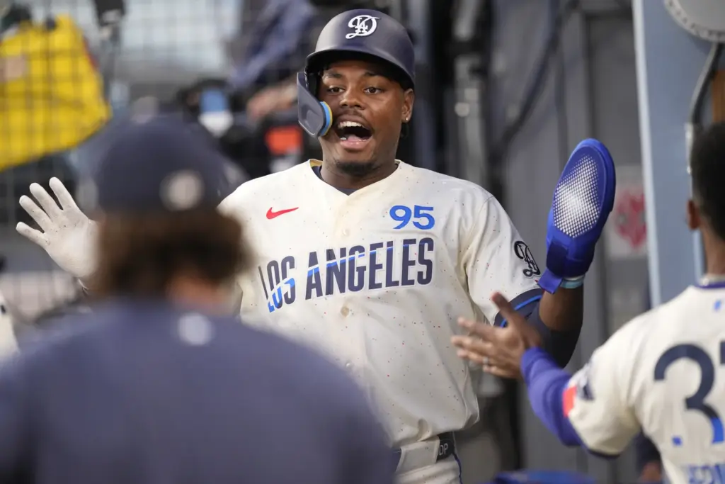 Dodgers’ Josue De Paula is congratulated by teammates in the...