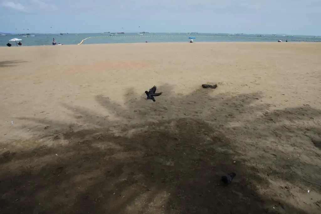 Tourists spend time on a beach in Pattaya, Thailand.