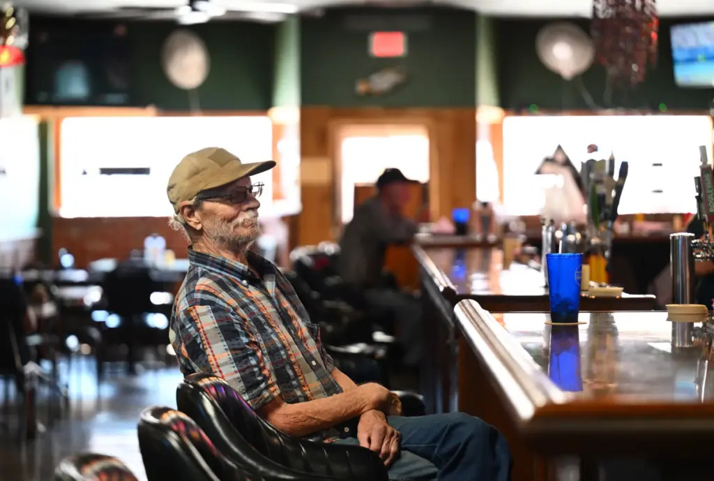 A customer at the Idle Hour bar in Anthony, Kansas,...