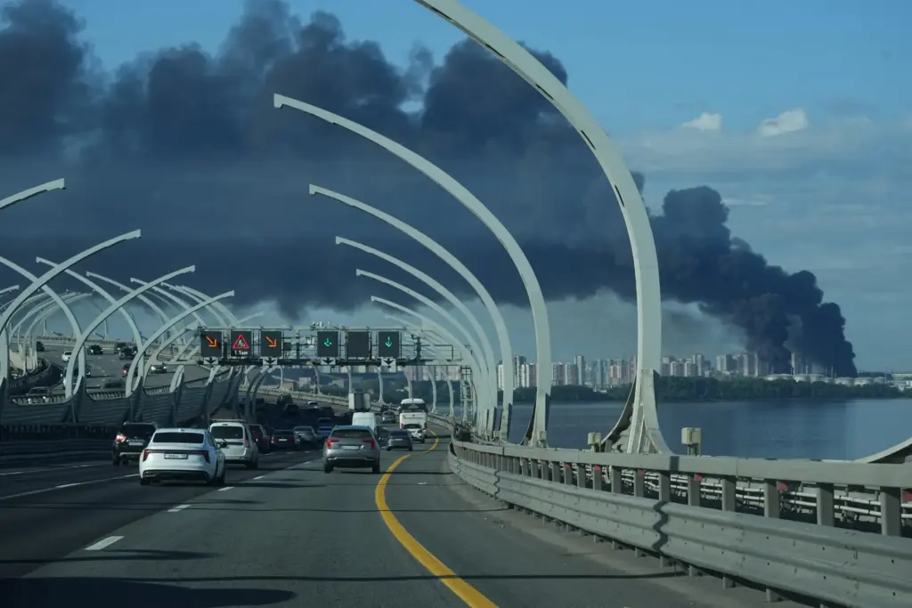 FILE – A plume of black smoke is seen over...