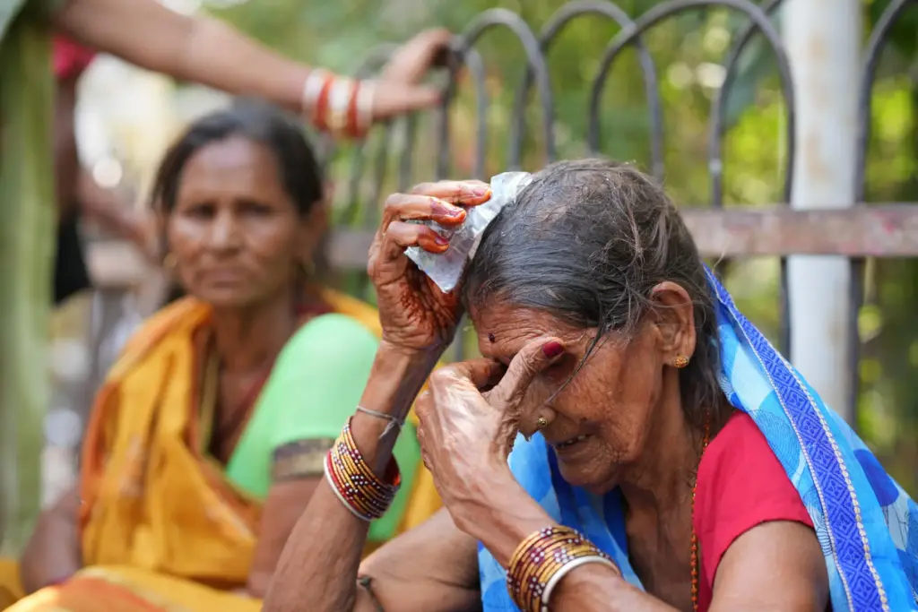 A woman cools herself off with an ice pack during a heat wave.